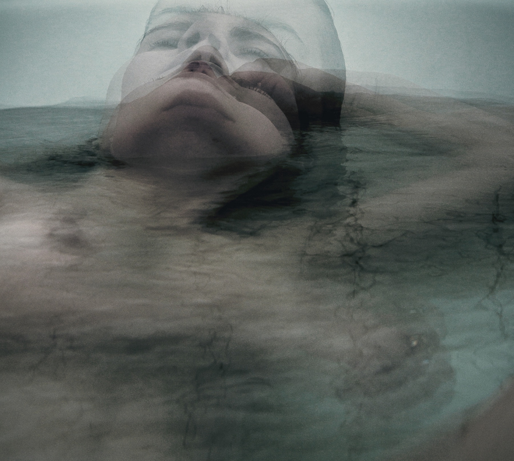 Figure emerging from water